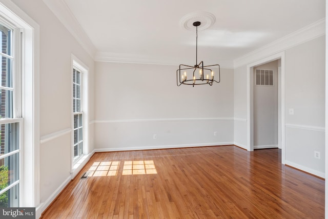 6513 Debhill Ln, Gainesville, VA 20155 - spare room featuring a chandelier, light wood-style floors, crown molding, and baseboards