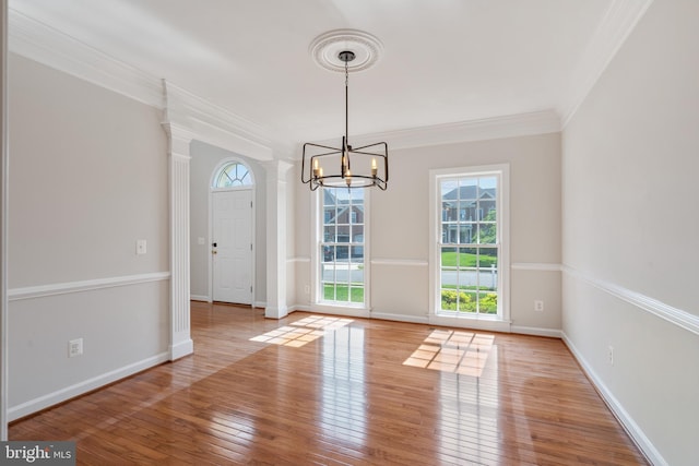 6513 Debhill Ln, Gainesville, VA 20155 - unfurnished dining area featuring a chandelier, hardwood / wood-style floors, ornamental molding, and baseboards