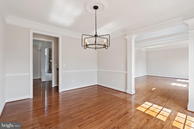 6513 Debhill Ln, Gainesville, VA 20155 - spare room featuring a chandelier, ornamental molding, wood finished floors, baseboards, and decorative columns
