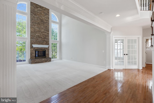 6513 Debhill Ln, Gainesville, VA 20155 - unfurnished living room featuring hardwood / wood-style floors, french doors, baseboards, and a stone fireplace