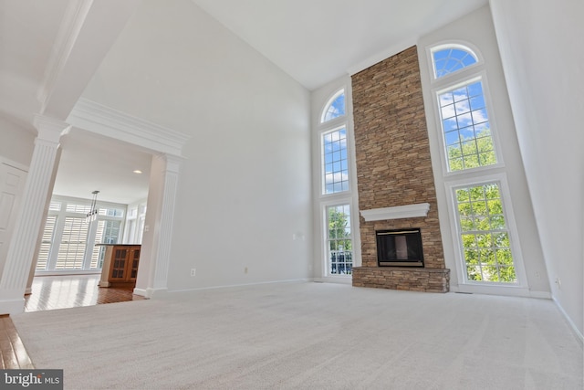 6513 Debhill Ln, Gainesville, VA 20155 - unfurnished living room featuring a high ceiling, a chandelier, baseboards, carpet, and ornate columns