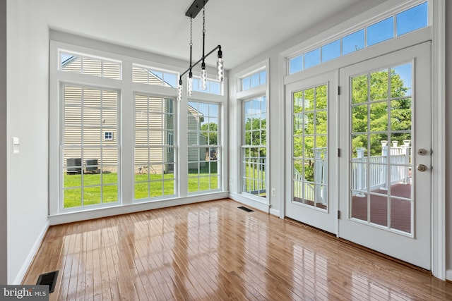 6513 Debhill Ln, Gainesville, VA 20155 - unfurnished sunroom featuring french doors, hardwood / wood-style floors, and baseboards