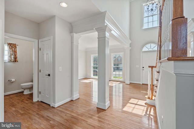 6513 Debhill Ln, Gainesville, VA 20155 - foyer entrance with ornate columns, light wood-style floors, baseboards, crown molding, and recessed lighting