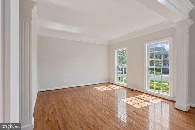 6513 Debhill Ln, Gainesville, VA 20155 - unfurnished room featuring decorative columns, hardwood / wood-style floors, crown molding, and baseboards