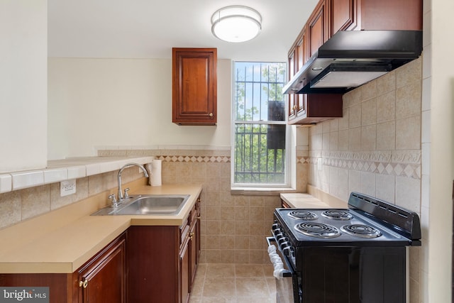 2400 Druid Hill Ave, Baltimore, MD 21217 - kitchen with black / electric stove, exhaust hood, tile walls, light countertops, and plenty of natural light