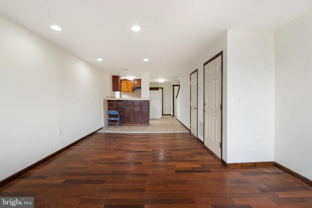 2400 Druid Hill Ave, Baltimore, MD 21217 - unfurnished living room featuring wood finished floors, recessed lighting, and bar