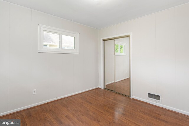 2400 Druid Hill Ave, Baltimore, MD 21217 - unfurnished bedroom featuring wood finished floors and a closet