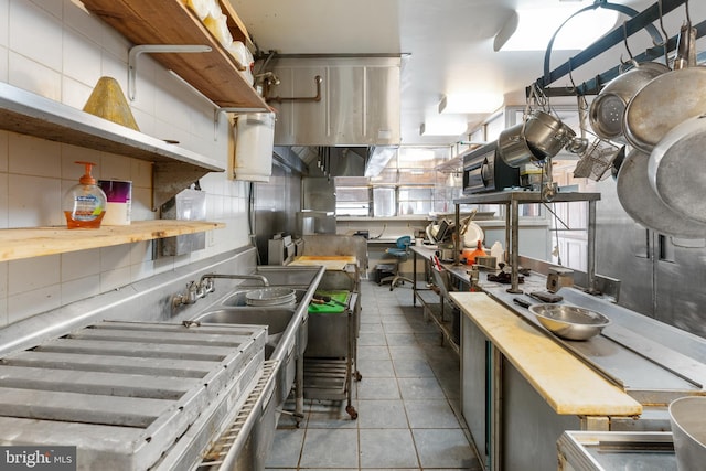 2400 Druid Hill Ave, Baltimore, MD 21217 - kitchen with decorative backsplash, open shelves, and tile patterned floors