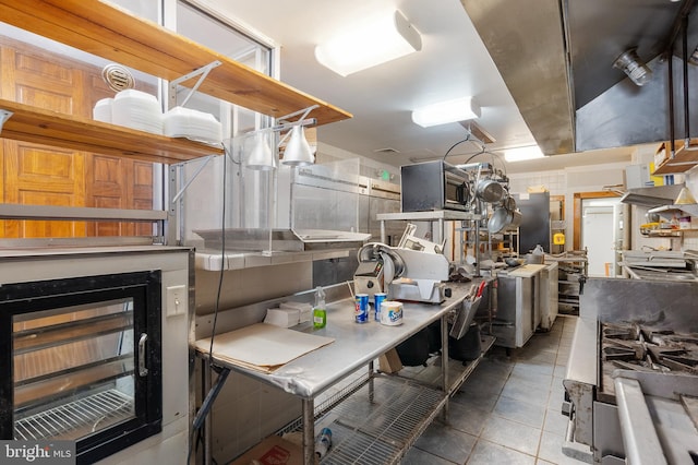 2400 Druid Hill Ave, Baltimore, MD 21217 - kitchen with tile patterned flooring and stainless steel microwave