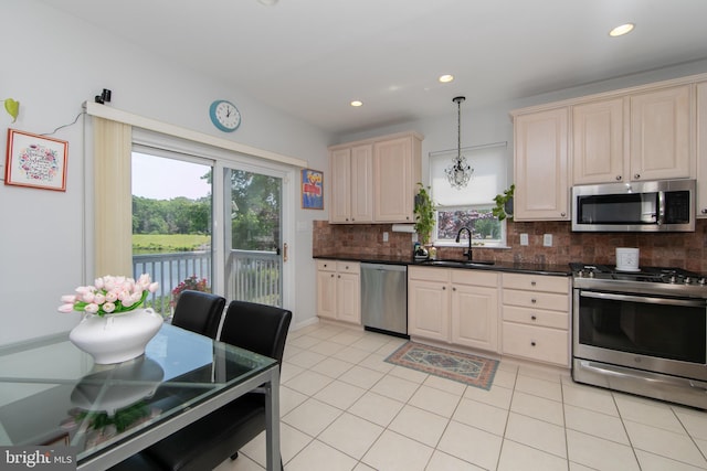 1504 Champlain Dr, Voorhees, NJ 08043 - kitchen featuring appliances with stainless steel finishes, a sink, tasteful backsplash, dark countertops, and light tile patterned floors