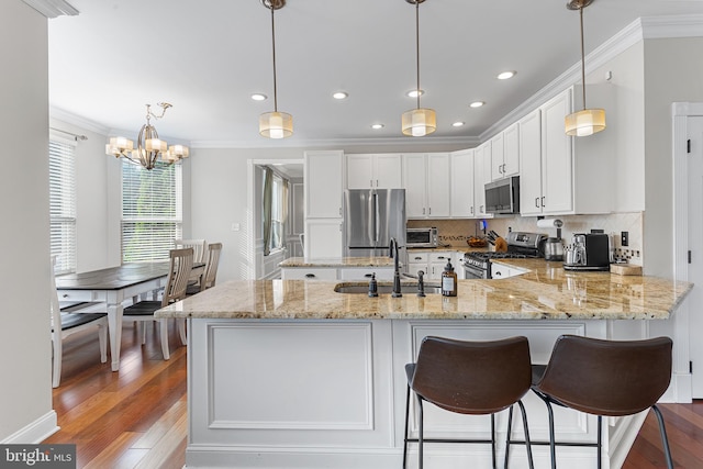 11 Bancroft Ln, Hainesport, NJ 08036 - kitchen with stainless steel appliances, a sink, crown molding, a peninsula, and white cabinets