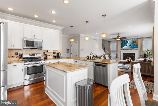 11 Bancroft Ln, Hainesport, NJ 08036 - kitchen featuring stainless steel appliances, a peninsula, ceiling fan, a sink, and decorative backsplash