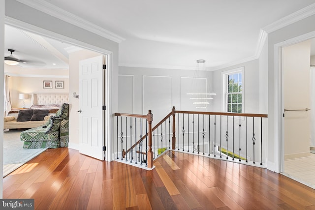 11 Bancroft Ln, Hainesport, NJ 08036 - corridor with wood-type flooring, an upstairs landing, crown molding, a chandelier, and baseboards