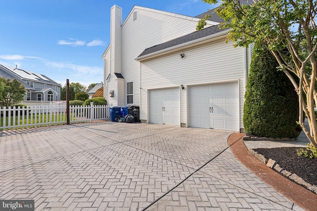 11 Bancroft Ln, Hainesport, NJ 08036 - view of side of home with decorative driveway and a chimney