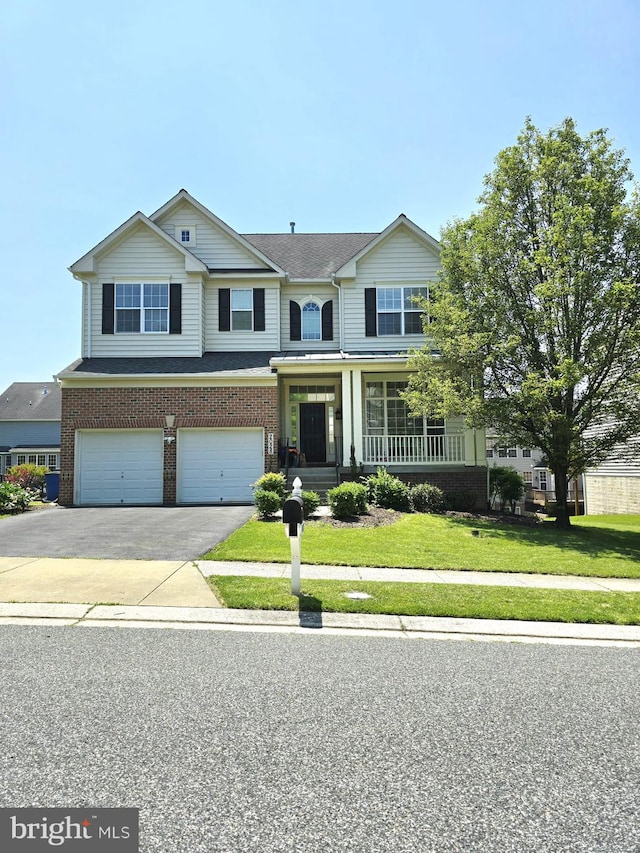 2028 Willowcrest Cir, Baltimore, MD 21209 - view of front of home with brick siding, driveway, a garage, a front yard, and covered porch
