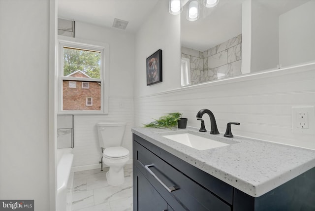3330 E Prospect Rd, York, PA 17402 - bathroom with marble finish floors, vanity, toilet, and wainscoting