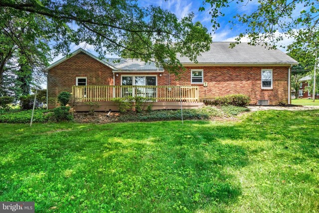 3330 E Prospect Rd, York, PA 17402 - rear view of house with brick siding, a wooden deck, and a lawn