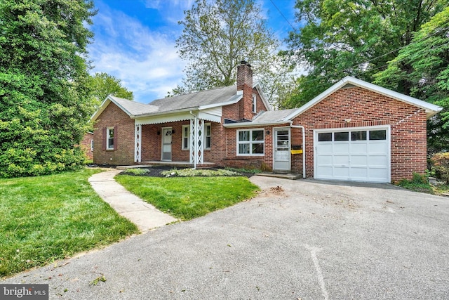 3330 E Prospect Rd, York, PA 17402 - view of front facade featuring an attached garage, a front yard, brick siding, and a chimney