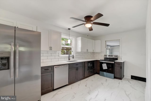 3330 E Prospect Rd, York, PA 17402 - kitchen with appliances with stainless steel finishes, a sink, light countertops, backsplash, and a ceiling fan