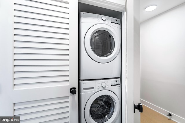 845 19th St NE Unit 4, Washington, DC 20002 - laundry room featuring stacked washing machine and dryer, wood finished floors, and baseboards