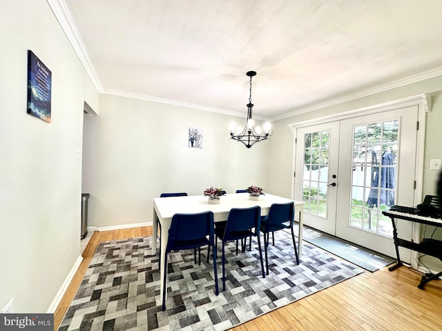 211 Franklin Ave, Berlin, NJ 08009 - dining room with light wood-style floors, french doors, a chandelier, and crown molding