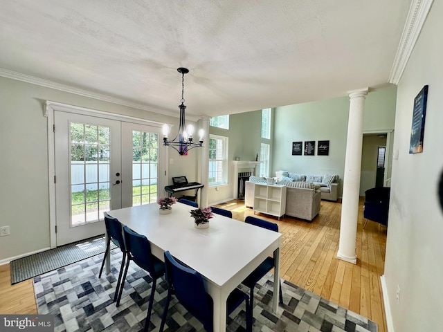 211 Franklin Ave, Berlin, NJ 08009 - dining area featuring ornamental molding, light wood-type flooring, french doors, a chandelier, and ornate columns