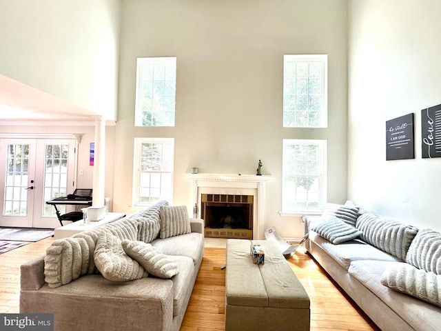 211 Franklin Ave, Berlin, NJ 08009 - living room featuring a high ceiling, french doors, a fireplace, and wood finished floors