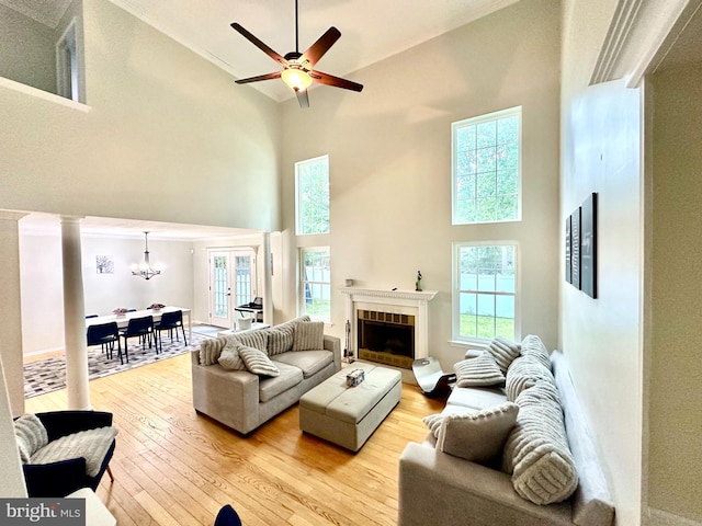 211 Franklin Ave, Berlin, NJ 08009 - living area featuring a high ceiling, a chandelier, light wood finished floors, plenty of natural light, and ornamental molding