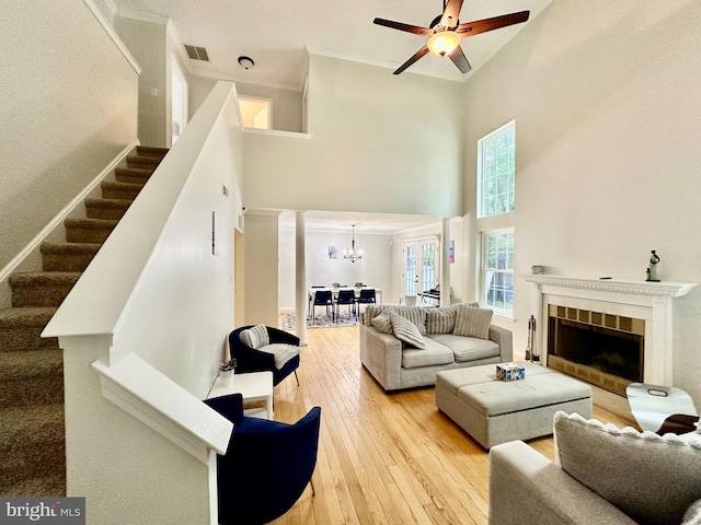 211 Franklin Ave, Berlin, NJ 08009 - living room featuring a towering ceiling, a chandelier, stairway, ornamental molding, and hardwood / wood-style flooring