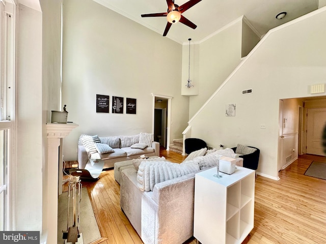 211 Franklin Ave, Berlin, NJ 08009 - living area with a ceiling fan, light wood finished floors, high vaulted ceiling, stairs, and ornamental molding