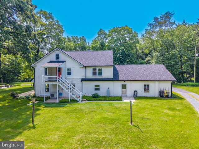 1034-1040 Twin County Rd, Honey Brook, PA 19344 - view of front facade with roof with shingles, stairs, a front lawn, and view of scattered trees
