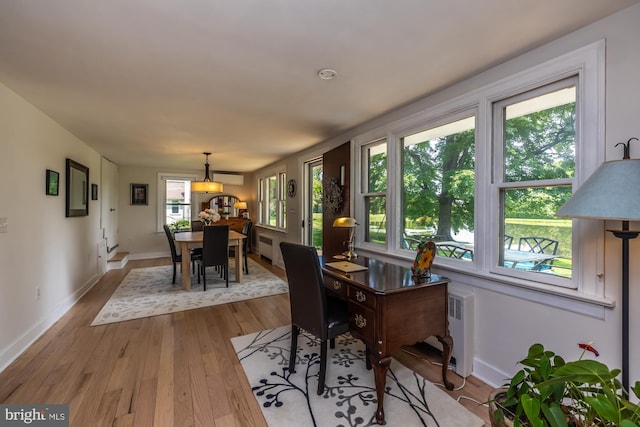 1034-1040 Twin County Rd, Honey Brook, PA 19344 - dining space featuring light wood-style flooring, a wall mounted AC, and baseboards