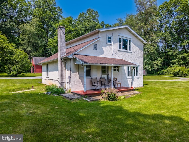 1034-1040 Twin County Rd, Honey Brook, PA 19344 - rear view of house with stucco siding, covered porch, a lawn, a chimney, and roof with shingles