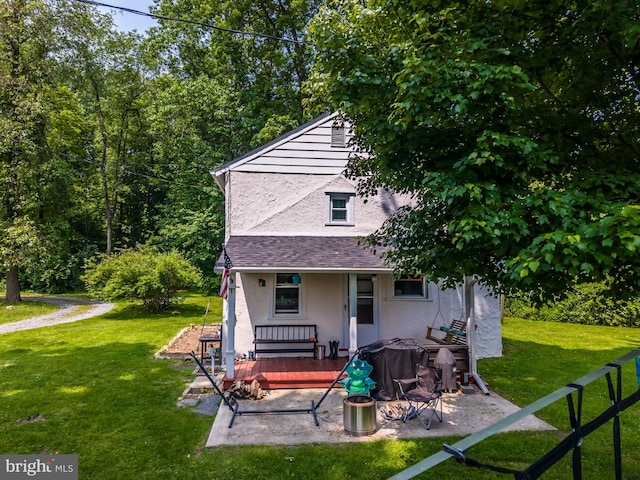1034-1040 Twin County Rd, Honey Brook, PA 19344 - rear view of property featuring stucco siding, a yard, covered porch, and a shingled roof