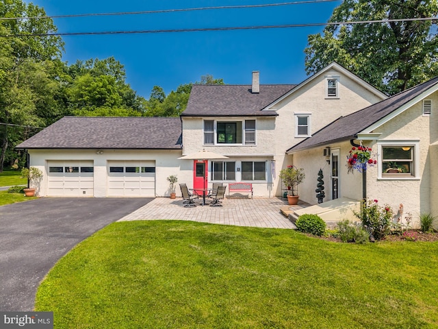1034-1040 Twin County Rd, Honey Brook, PA 19344 - rear view of property with stucco siding, driveway, and an attached garage