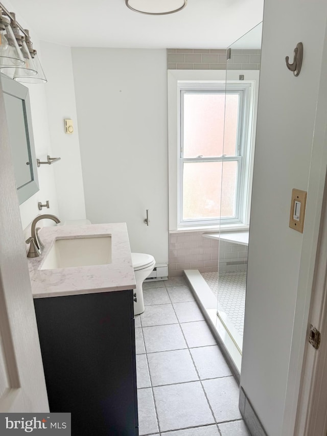 117 E Montgomery Ave, Hatboro, PA 19040 - full bath featuring vanity, toilet, tiled shower, tile patterned floors, and baseboard heating