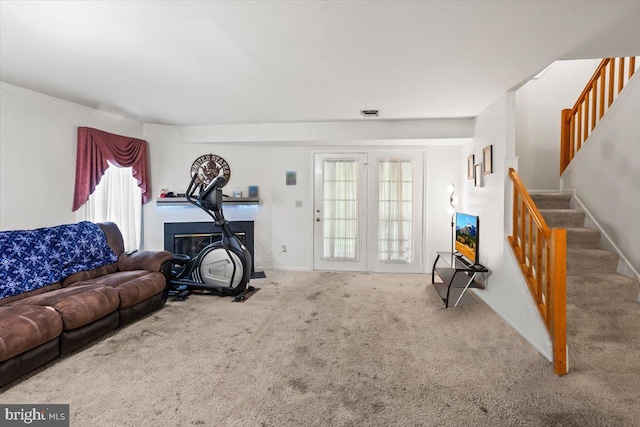 1417 Cambridge Ct, Palmyra, PA 17078 - carpeted living room with stairway, a glass covered fireplace, and baseboards