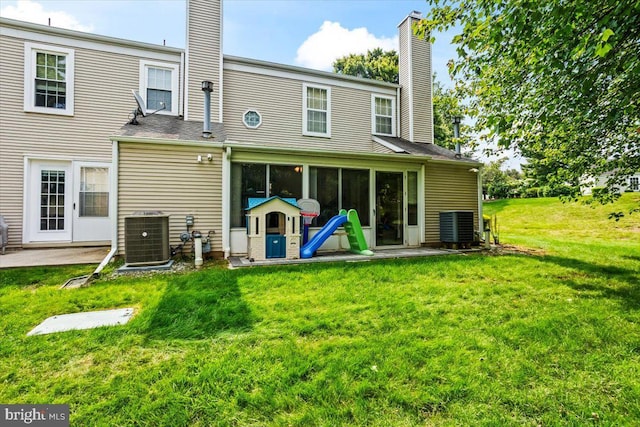 1417 Cambridge Ct, Palmyra, PA 17078 - back of property with a chimney, cooling unit, and a lawn