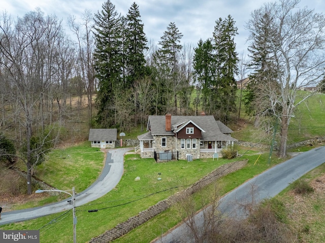 00 Devereux Rd, Glenmoore, PA 19343 - view of front of property with stone siding, a chimney, a front lawn, and an outbuilding