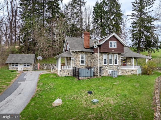 00 Devereux Rd, Glenmoore, PA 19343 - back of house with stone siding, a porch, a yard, a chimney, and roof with shingles