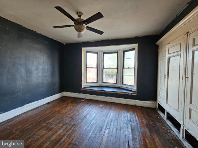 634 N 56th St, Philadelphia, PA 19131 - unfurnished bedroom featuring baseboards, hardwood / wood-style flooring, and ceiling fan