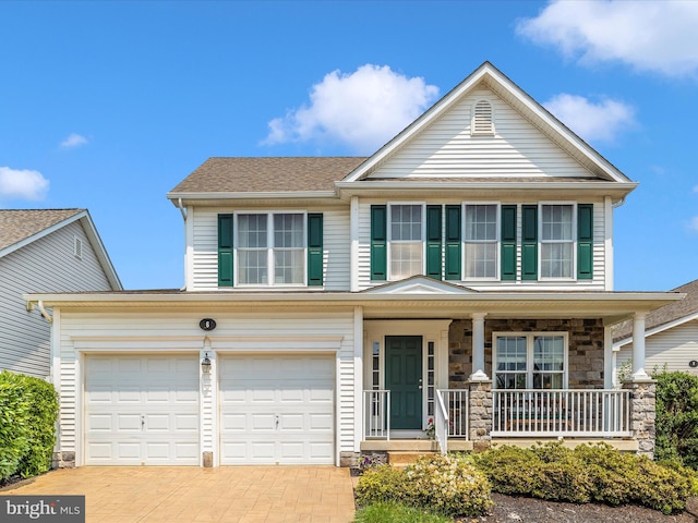 6 Stine Ct, Middletown, MD 21769 - view of front of house with a porch, decorative driveway, a garage, stone siding, and a shingled roof