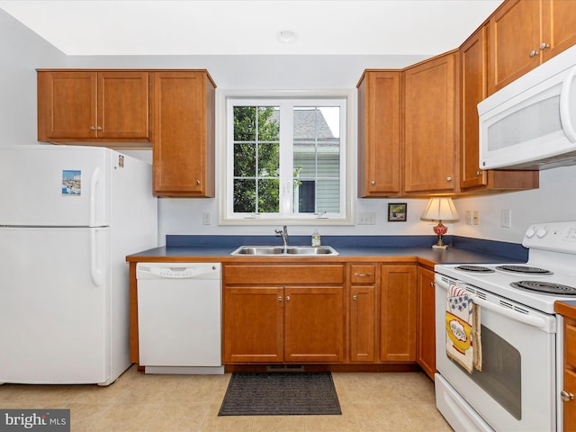 6 Stine Ct, Middletown, MD 21769 - kitchen featuring white appliances, brown cabinetry, light tile patterned flooring, and dark countertops