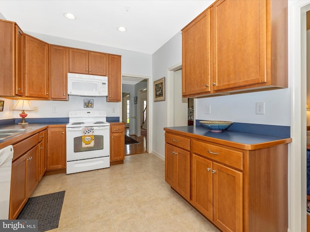 6 Stine Ct, Middletown, MD 21769 - kitchen with white appliances, brown cabinets, dark countertops, recessed lighting, and light tile patterned flooring