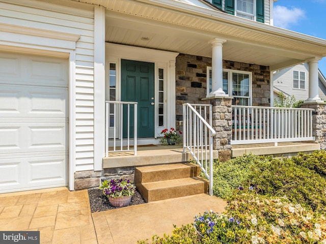 6 Stine Ct, Middletown, MD 21769 - entrance to property featuring covered porch, stone siding, and a garage