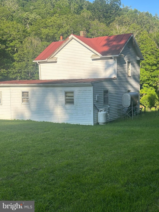 8787 Crooked Run Rd, Basye, VA 22810 - view of property exterior featuring a lawn, heating fuel, and a view of trees