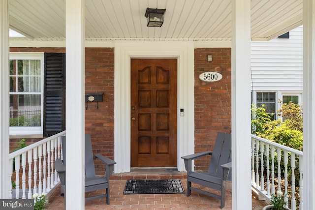 5600 11th St N, Arlington, VA 22205 - view of exterior entry featuring a porch and brick siding