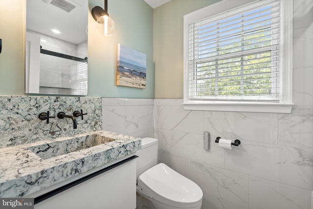 5600 11th St N, Arlington, VA 22205 - bathroom with toilet, vanity, a shower, and tile walls