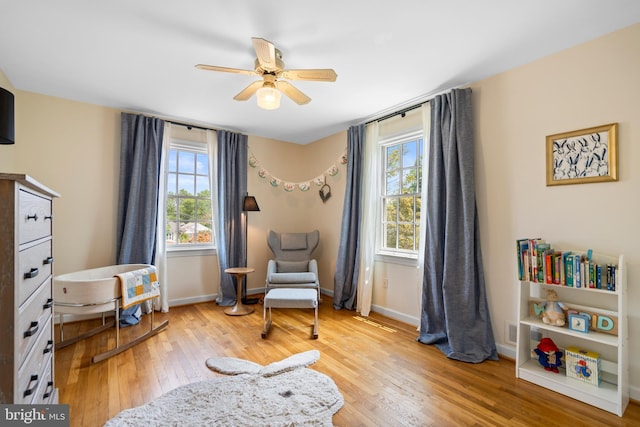 5600 11th St N, Arlington, VA 22205 - living area with healthy amount of natural light, light wood-style floors, ceiling fan, and baseboards
