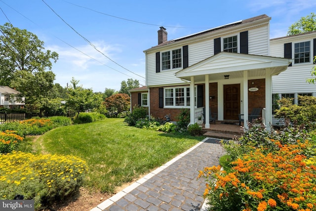 5600 11th St N, Arlington, VA 22205 - view of front of home featuring brick siding, a chimney, a front lawn, and a porch